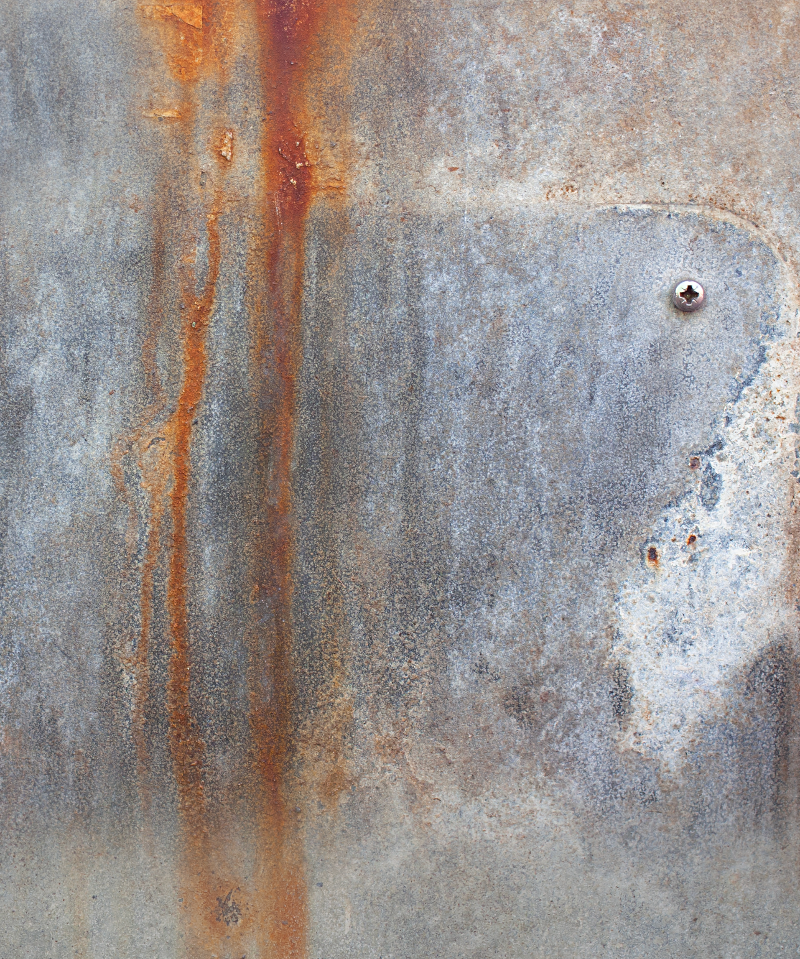 A close-up of a weathered metal effect vinyl photography backdrop with a textured grey finish, featuring vertical orange rust streaks and a small metallic screw head on the right side.