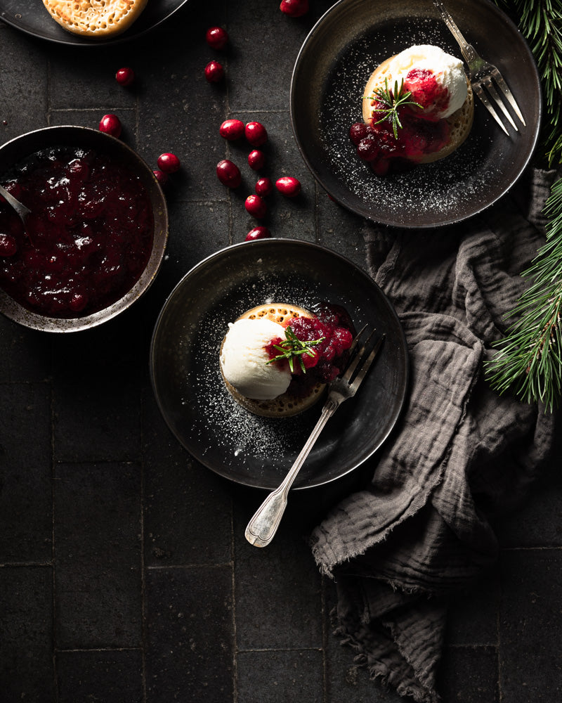 Christmas Crumpets styled on a a vinyl photography backdrop captures from an old Victorian floor consisting of aged black and grey tiles with detailed grout lines.