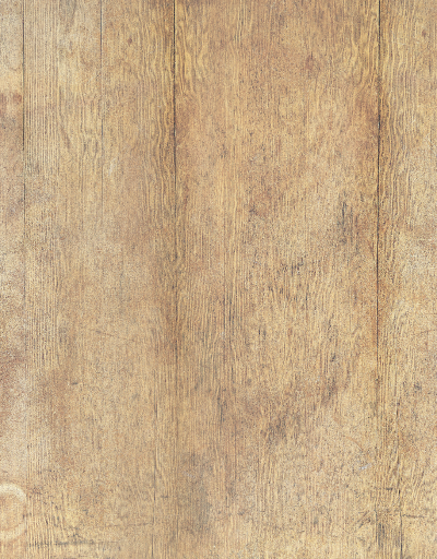 A flat lay of a chicken casserole, glasses and plates styled on a wooden table effect photography backdrop with a washed out pine or oak appearance.