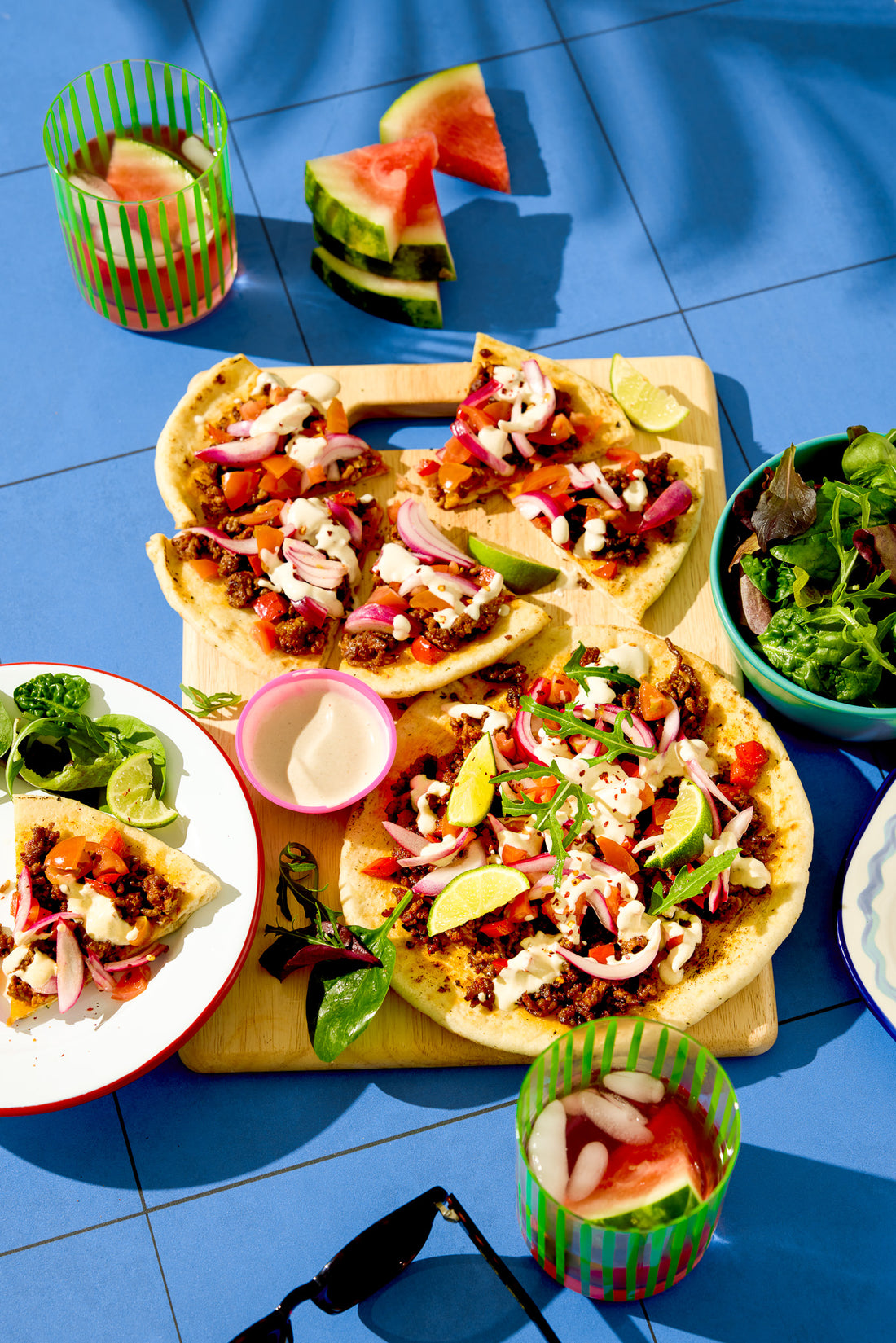 Tacos shot on a blue tile backdrop
