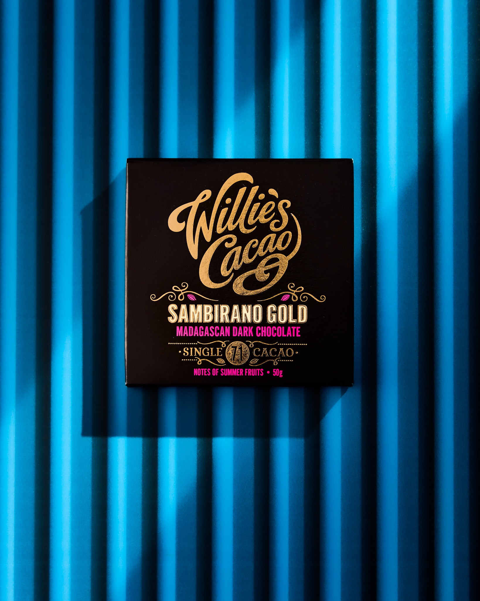 Commercial chocolate photography styled on a bright blue corrugated metal shutter-effect photography backdrop.