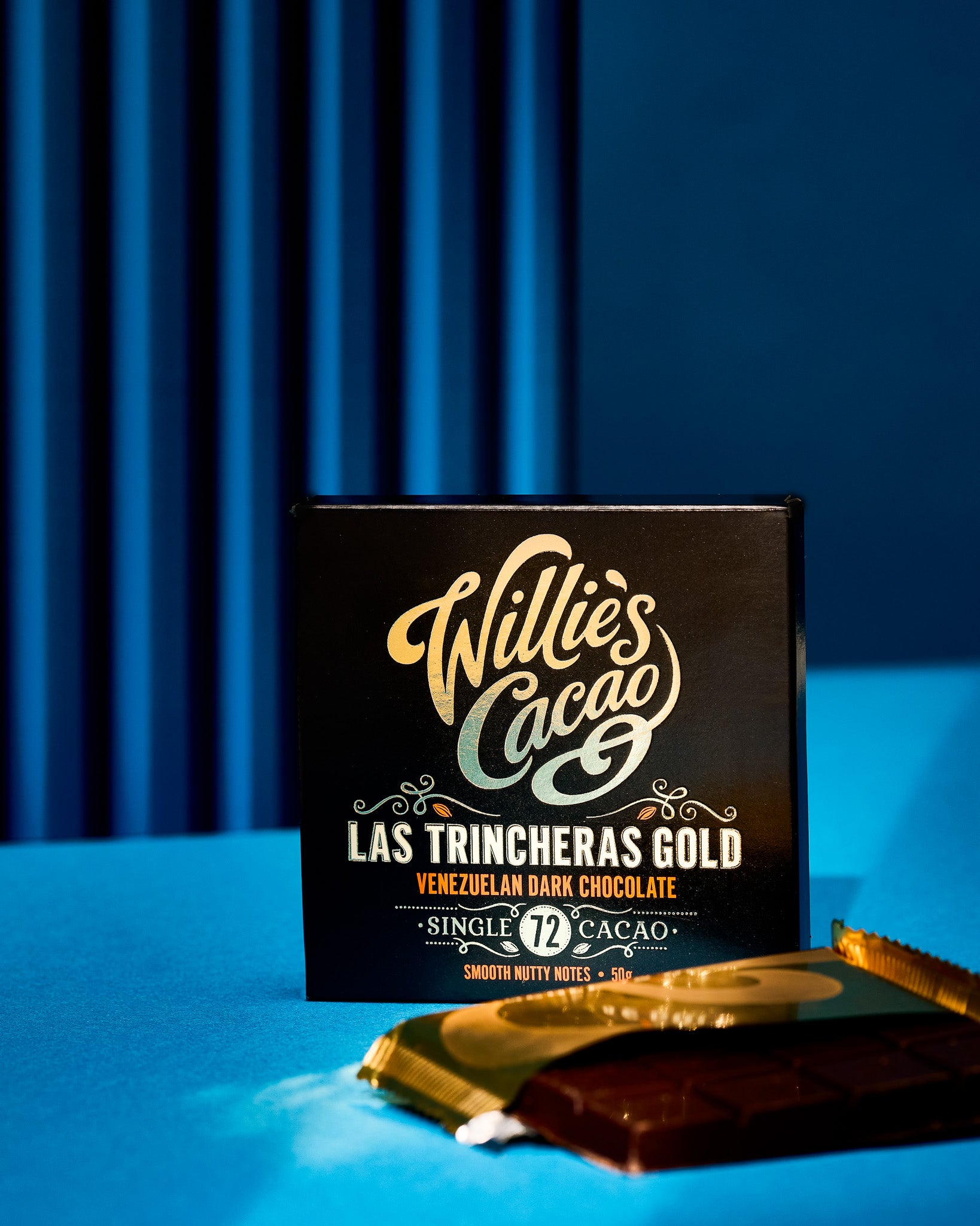 Commercial chocolate photography styled on a bright blue corrugated metal shutter-effect photography backdrop.
