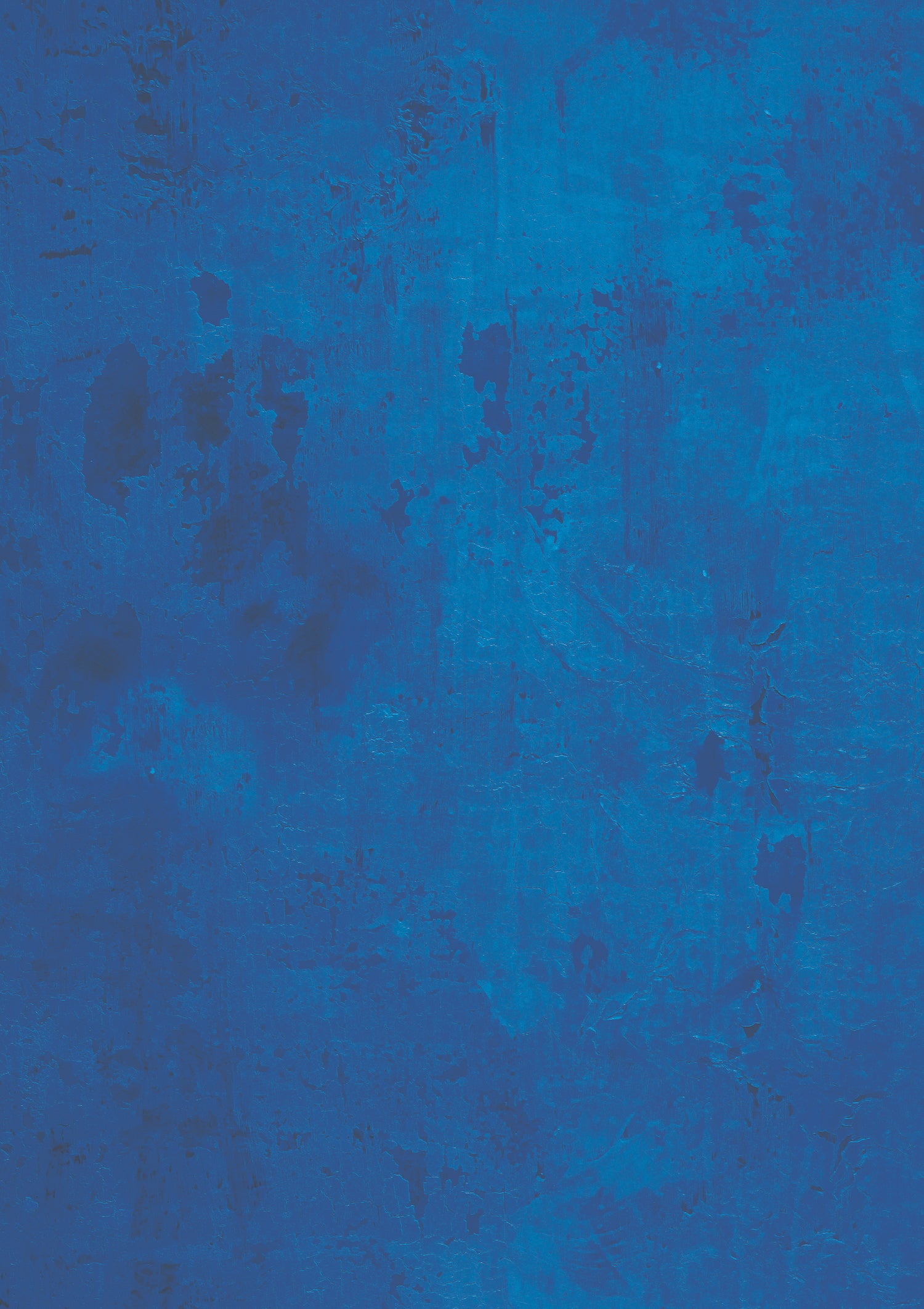 A close-up image of a cobalt blue vinyl photography backdrop with a layered paint effect over wood.