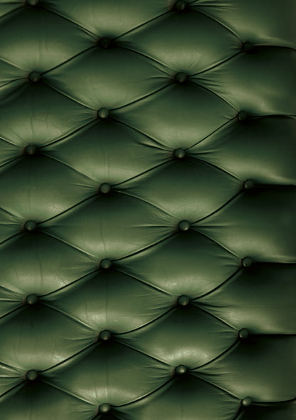 A dark green leather effect photography backdrop with button details, resembling a Chesterfield sofa.