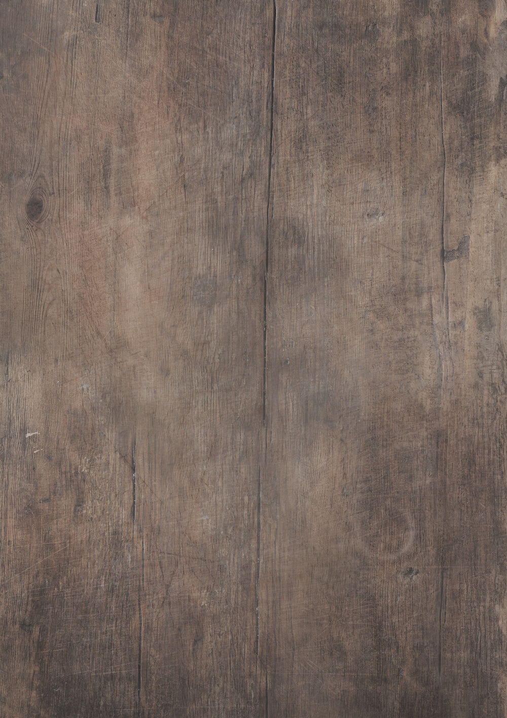 A close-up view of a dark wood table effect photography backdrop with a soft woodgrain effect.