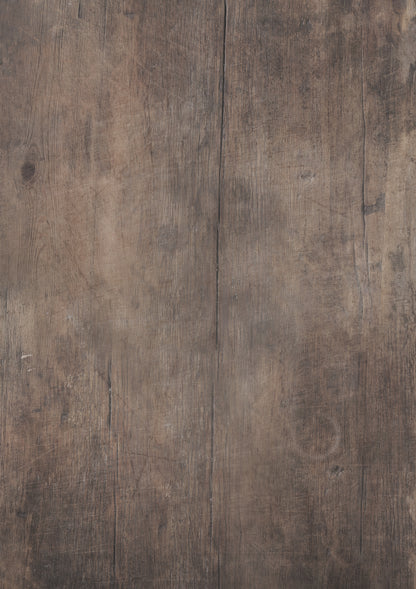 A close-up view of a dark wood table effect photography backdrop with a soft woodgrain effect.