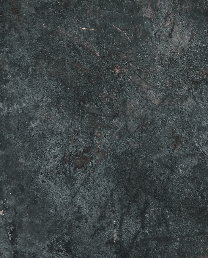 Close up of a dark grey textured vinyl photography backdrop with a vintage metallic appearance.