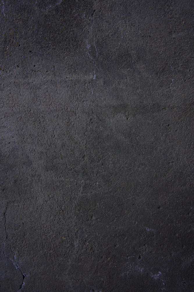 Dark textured vinyl photography backdrop captured from a weathered black plaster wall with subtle gray undertones and fine cracks.
