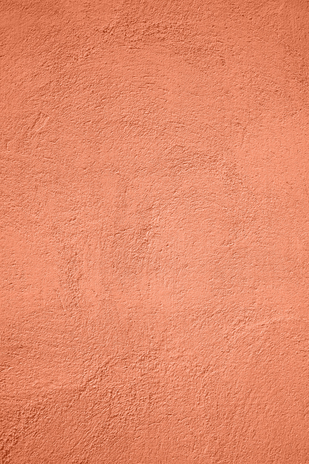 A warm orange coral stucco-effect vinyl photography backdrop for food styling and product photography