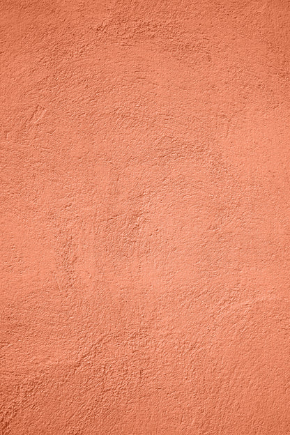 A warm orange coral stucco-effect vinyl photography backdrop for food styling and product photography