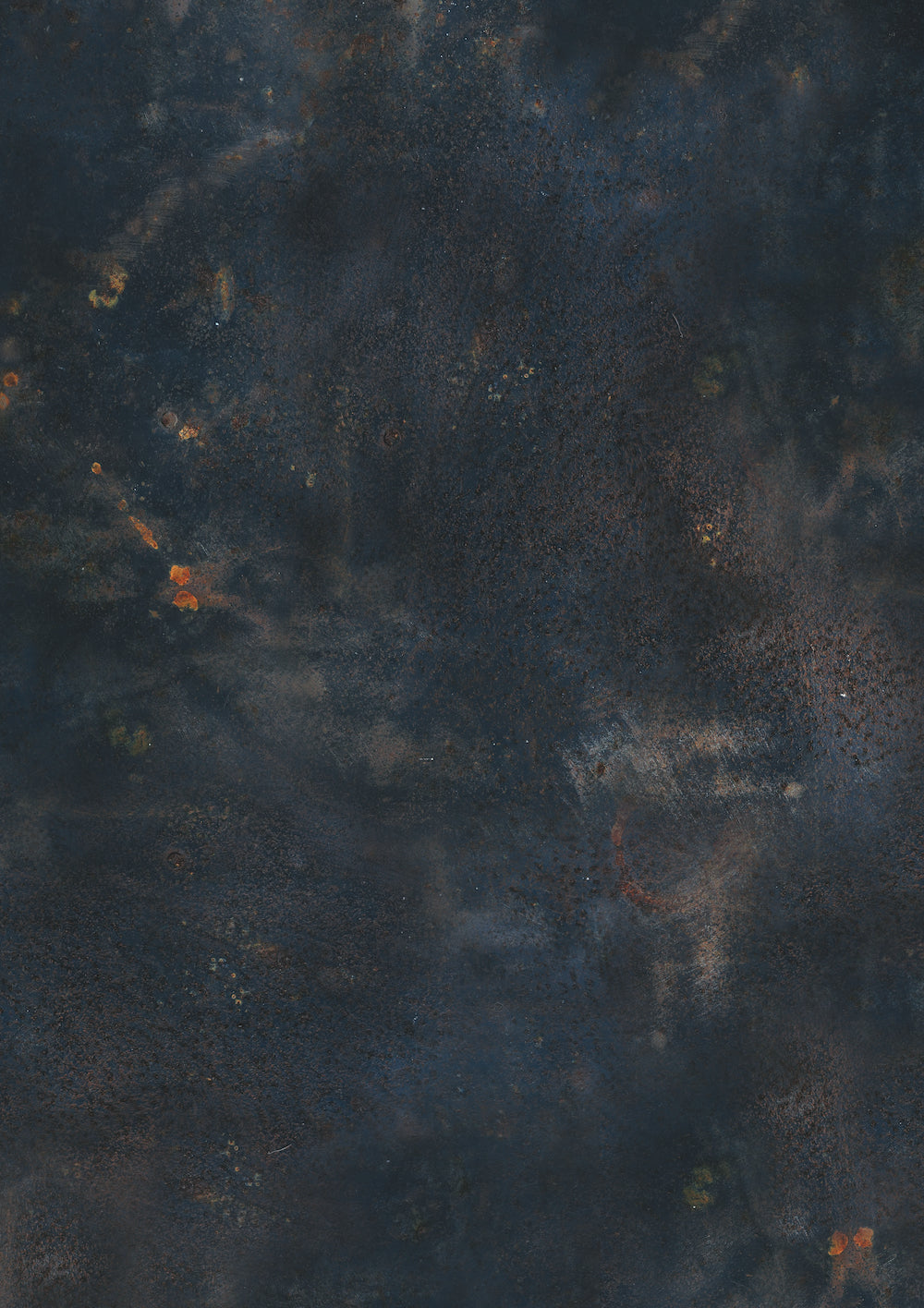 A dark blue vinyl photography backdrop with a warm rust effect showcasing varying shades of navy blue, taupe and rust highlights.
