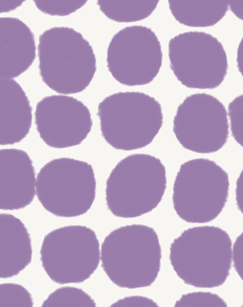 Close up of a purple polka dot vinyl photography backdrop with an off-white background.