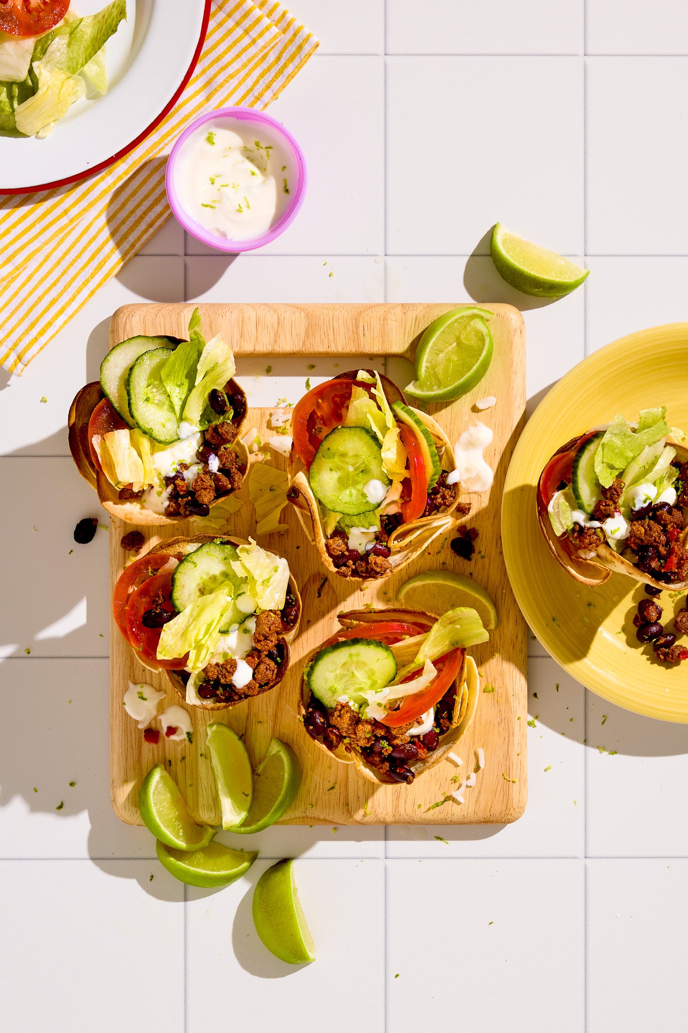 A flat lay of Mexican fast food styled on a white tile-effect vinyl photography backdrop with grid lines.