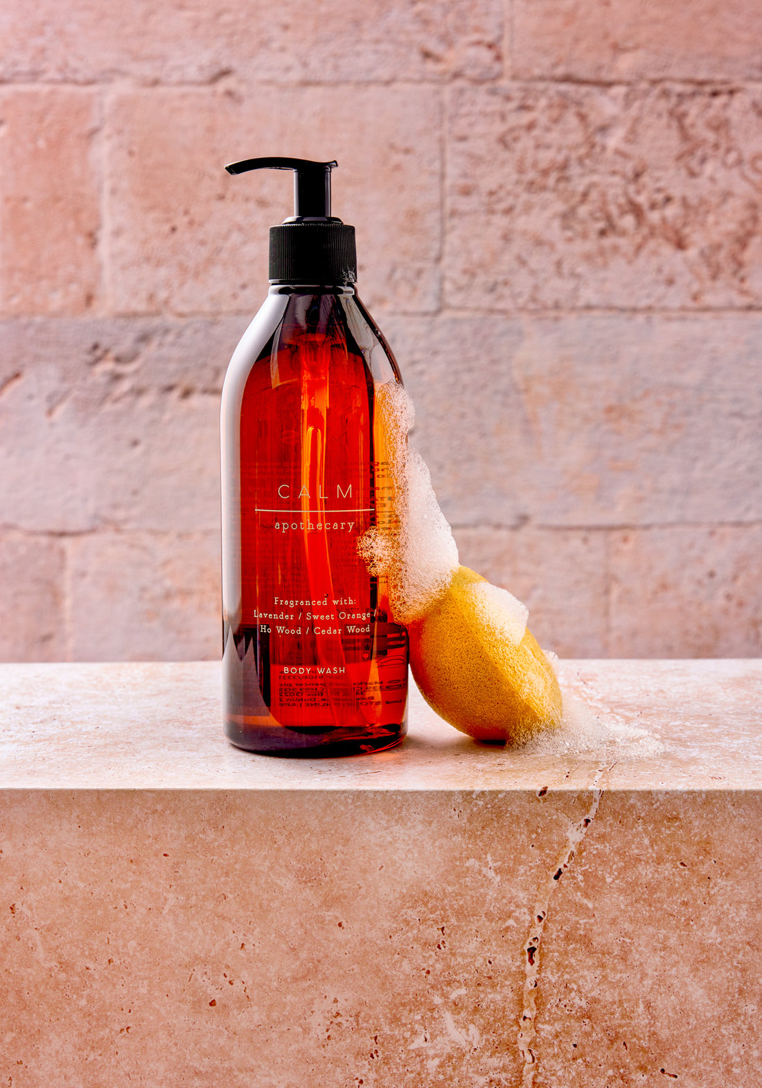 Marks and Spencer Calm apothecary range photographed against a beige and grey stone tile-effect vinyl photography backdrop.