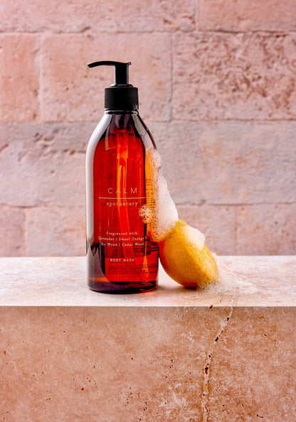 Marks and Spencer Calm apothecary range photographed against a beige and grey stone tile-effect vinyl photography backdrop.