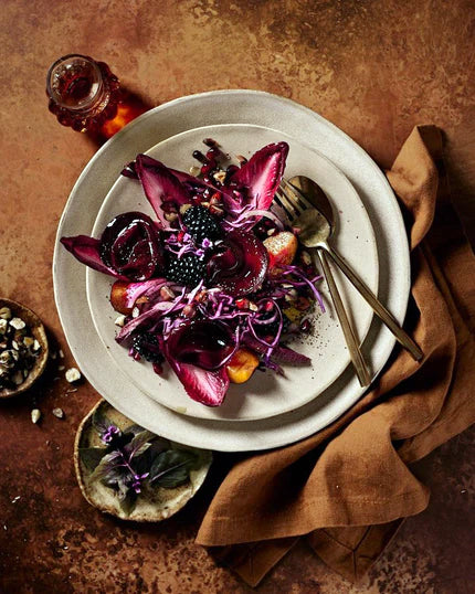 Gourmet dish with purple cabbage and blackberries on a bright copper food and product vinyl photography backdrop