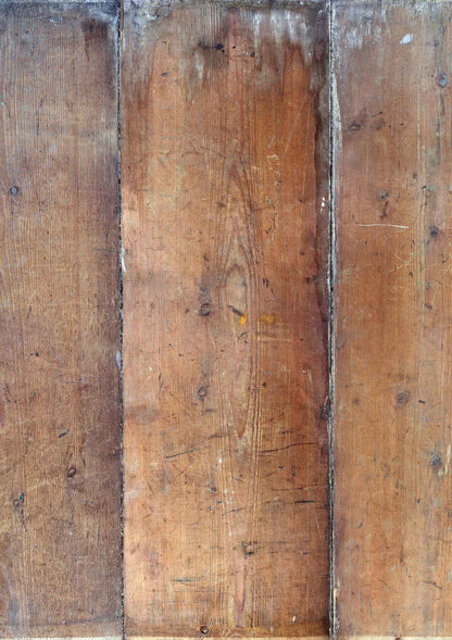 A vinyl photography backdrop featuring split wood planks with a vintage pine effect and some white aging on one end.