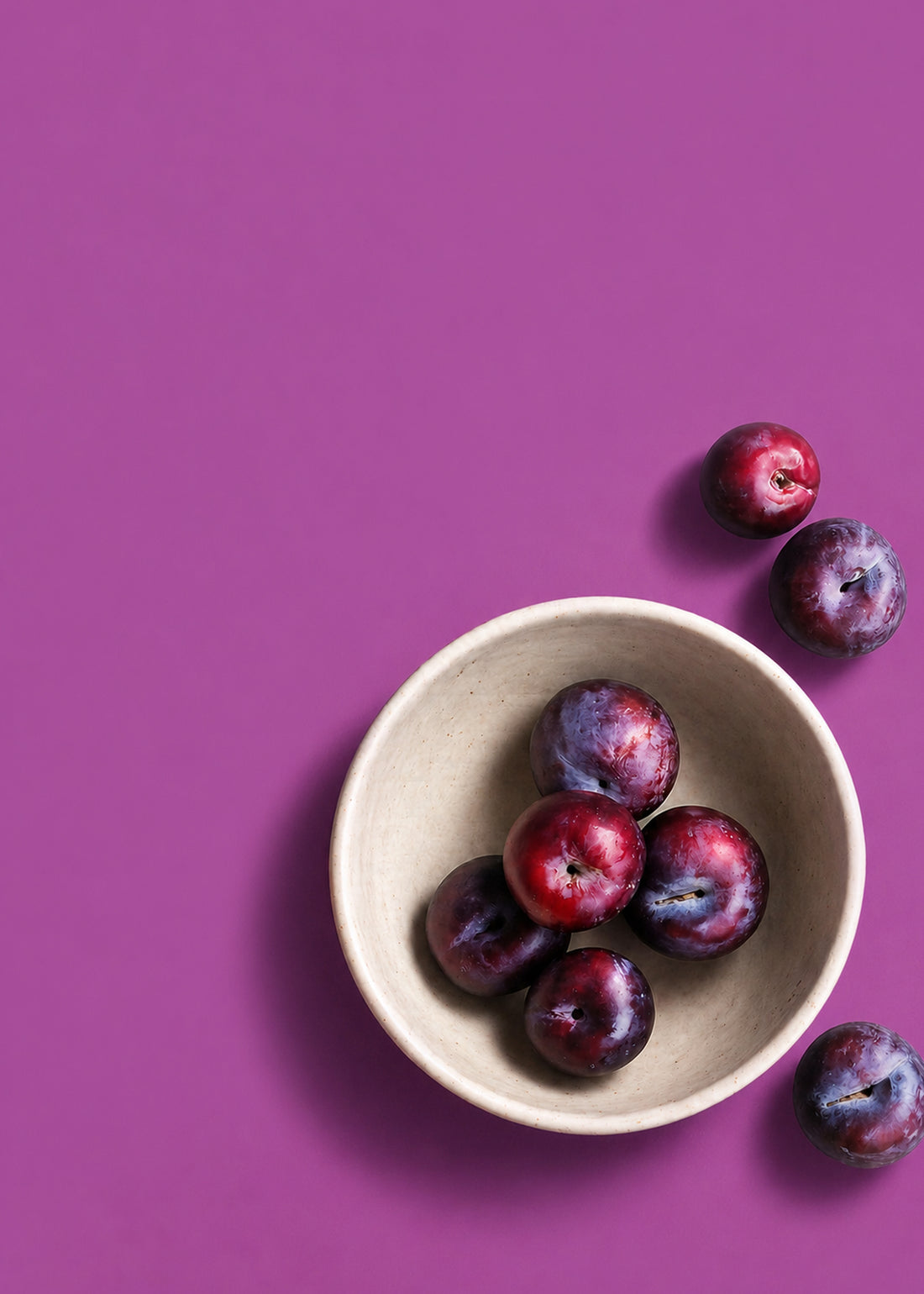 Plum bowl on a purple background