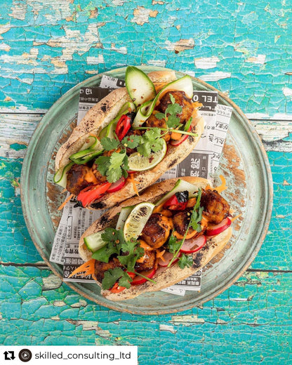 Bright flat lay of tacos styled with a turquoise and green coloured flaky wood effect vinyl photography backdrop, designed for food and product photography.