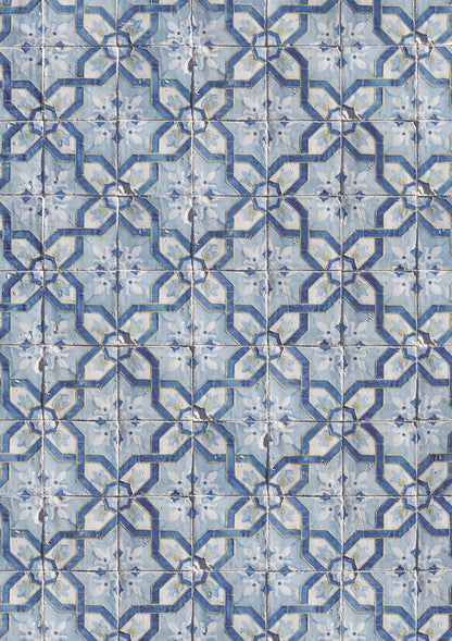 A close-up view of a photography backdrop featuring a Portuguese geometric tile pattern in blue, white, and yellow.