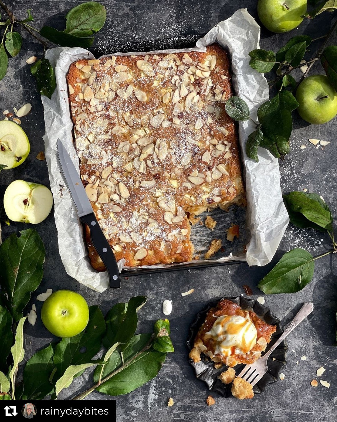 A flat lay of an apple pie styled on a grungy grey-black vinyl photography backdrop.