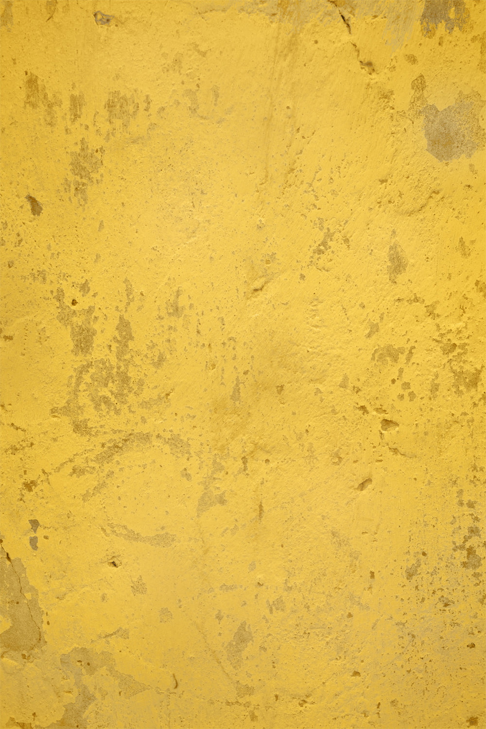 A close-up of a yellow vinyl photography backdrop with a weathered plaster design for food styling and product photography.