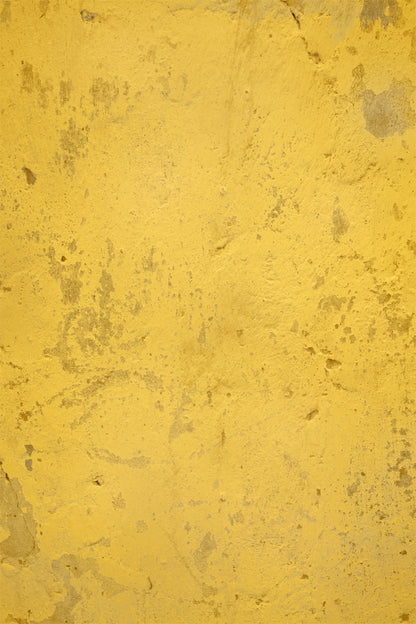 A close-up of a yellow vinyl photography backdrop with a weathered plaster design for food styling and product photography.