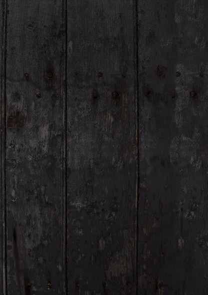 A close-up view of a vinyl photography backdrop depicting an old wood panel effect in dark grey and black tones