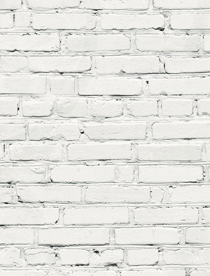 A close up of a white brick wall-effect vinyl photography backdrop with varying shades of grey and mortar lines designed to mimic a brick wall texture.