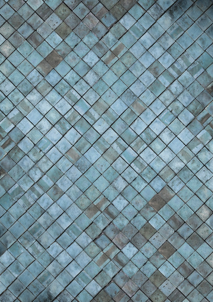 A close-up image of a blue tile effect photography backdrop with a weathered patina in greys and taupe.
