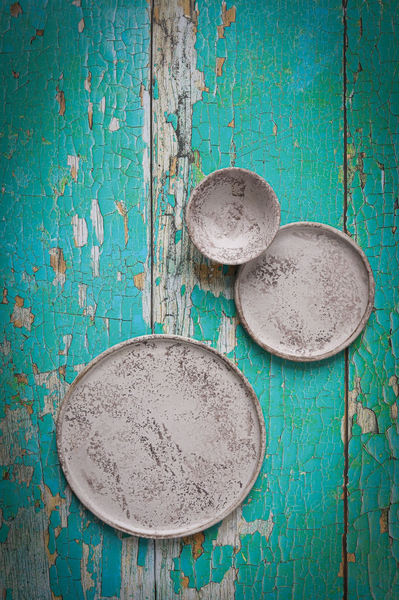 Grey ceramics on a turquoise flaky wood-effect vinyl photography backdrop designed for food and product photography.