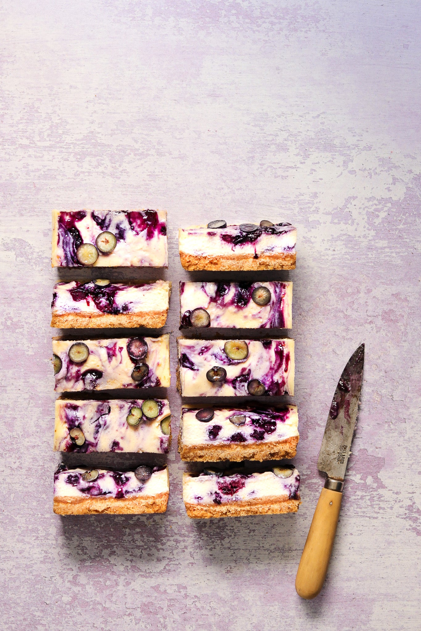 Flat lay of handmade cheesecake on a  textured lilac paint effect vinyl photography backdrop