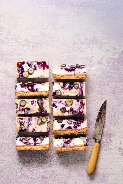 Flat lay of handmade cheesecake on a  textured lilac paint effect vinyl photography backdrop